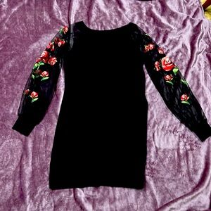 Festive Black sweater dress; sheer sleeves with red rose appliqué.